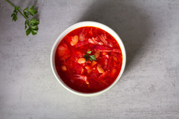 Soup made with vegetables, meat, bean and beet root: borsht, bortsch, borshch, borscht. Traditional dish in Ukraine, Russia, Poland. View from above, top studio shot