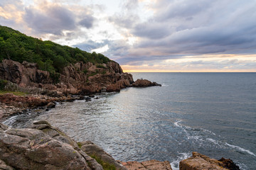 Rocky beach during sunset at Kullaberg in Sweden.