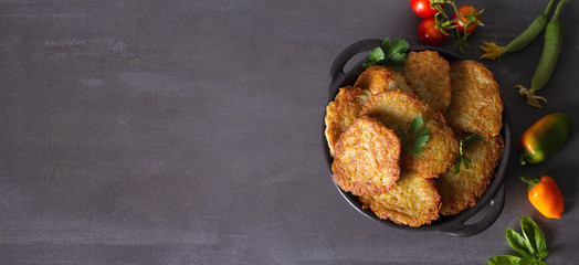 Potato Cakes. Vegetable fritters, latkes, draniki. Vegetable pancakes. View from above, top studio shot, copy space