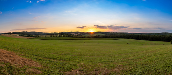 panorama of czech landscape at sunset. fields and forests and sky with clouds