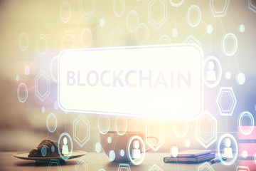 Double exposure of crypto currency theme drawing hologram over coffee cup background in office....