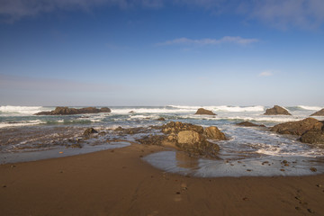 Waves breaking on rocks on the beach