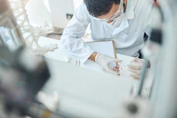 Male scientist working with a test specimen