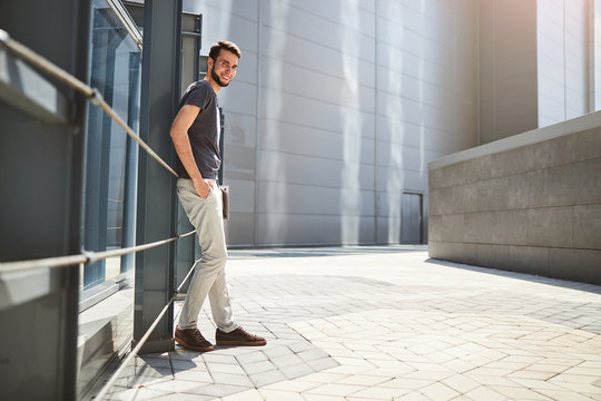 Attractive Guy With A Laptop Standing Outside