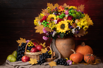 Autumn still life with leaf, sunflowers, pumpkin and fruits