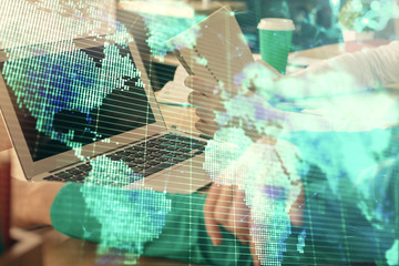 Double exposure of man and woman working together and financial theme hologram. international business concept. Computer background.