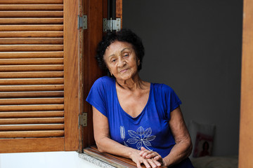 Portrait brazilian mature woman at window