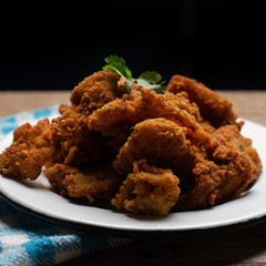 Fish chicharron with mayonnaise and onion on wooden background