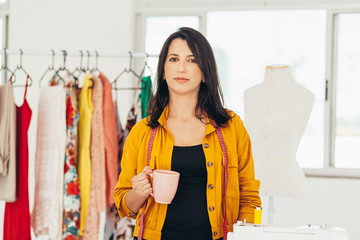 Seamstress working at her workplace. Latin woman owner of small business.