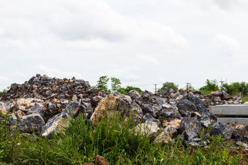 Heaps of granite boulders near the weeds.