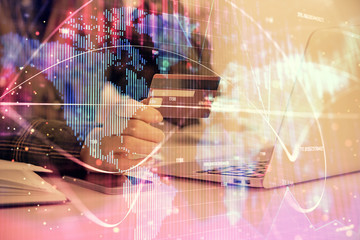 Multi exposure of woman on-line shopping holding a credit card and financial theme drawing. Business E-commerce concept.