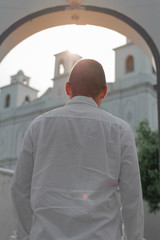 man looking at a church with hopes of a better tomorrow. man back