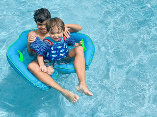 family brothers relaxing by the pool in Naples Florida 