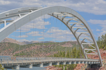 Cart Creek Arch Bridge stretched across a red rock canyon in Flaming Gorge National Park, Manila Utah