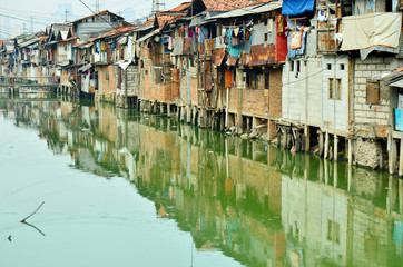 Fototapeta na wymiar Slum house on the edge of a canal in Jakarta
