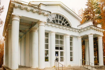 Beautiful old house among autumn yellow trees, antique building