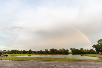 Rainbow in a field above a lake in New Orleans, Louisiana