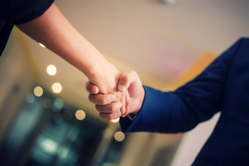 Business people shaking hands, between meeting in seminar room