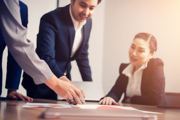 Teamwork with business people analysis cost graph in meeting room