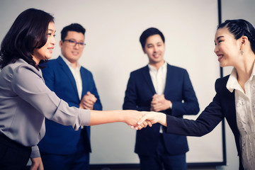 Fototapeta na wymiar Business people shaking hands, between meeting in seminar room