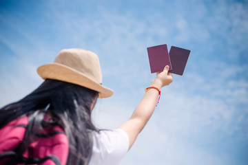 Traveling people concept. hand showing the passport on sky