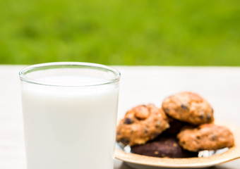  A glass of milk and cookies  on the table , out door   Chiangmai  Thailand               