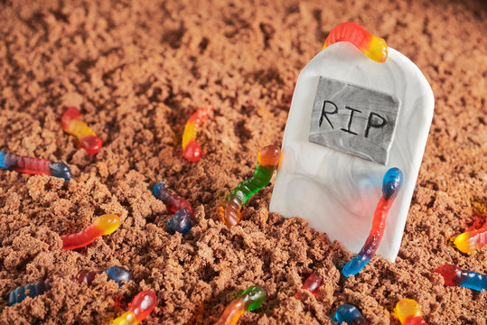 Gummy Worms In Chocolate Cake Ground Around A Sugar Gravestone, Halloween Food