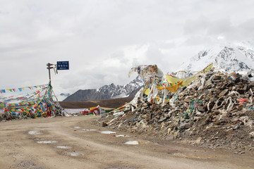 View of mountains with the prayer flags at XueGeLa mountain pass in Tibet, China