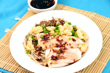Steamed Rice Noodle roll or rice noodle paste with bean sprout with many topping and black sweet sauce.