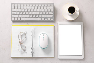 Modern tablet computer, keyboard, notebook, coffee and PC mouse on light background
