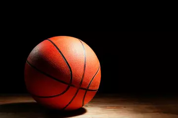 Fototapeten Ball for playing basketball on table against dark background © Pixel-Shot