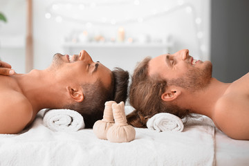 Happy gay couple relaxing in spa salon