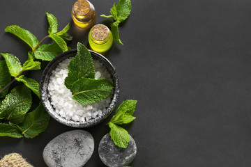 Spa composition with mint and sea salt on dark background