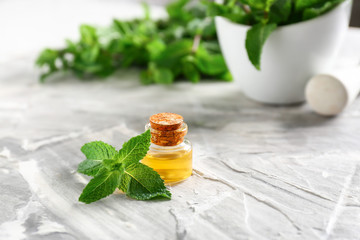 Mint essential oil on table
