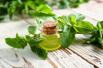 Mint essential oil on table