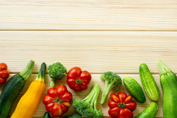 Set of various vegetables on a light wooden background. Space for text