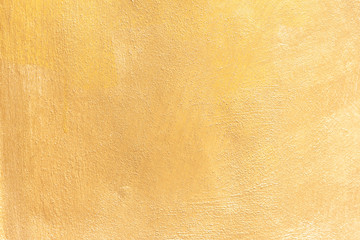 Textures of gold uneven cement wall for the background.