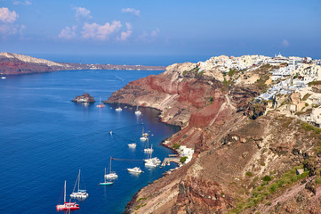 Santorini Caldera landscape in Oia with sailing boats in the sea