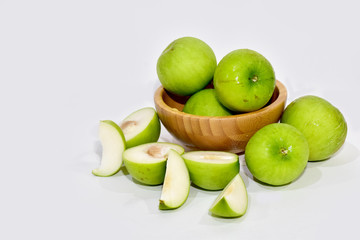 Closeup of Fresh Green jujube in a wooden bowl isolated on white background, Selective Focus.