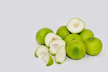 Fototapeta na wymiar Closeup of Fresh a Pile of green jujube isolated on white background, Selective Focus.