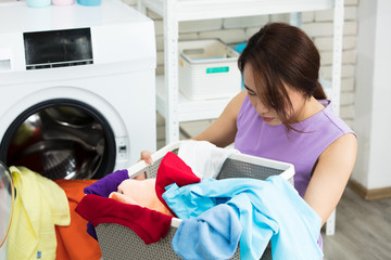 Asian women sorting out their clothes, preparing to be washed.