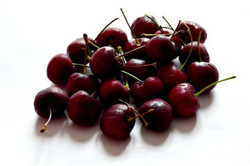 Fresh Ripe cherries with water drops isolated on white background.
