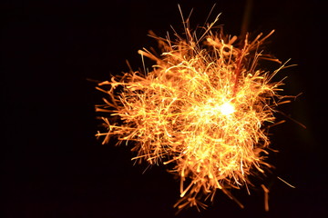 Fototapeta premium burning sparkler on black background