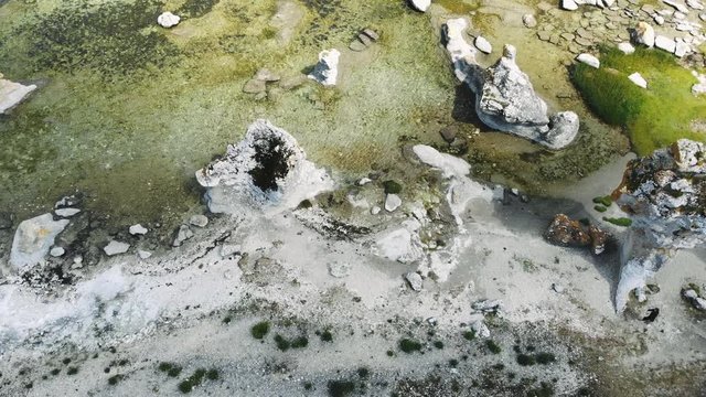 Drone flying over tall sea stacks and clear waters, Gotland, Sweden