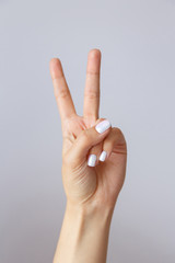 The hand shows the number two. Countdown gesture or sign. Sign language.