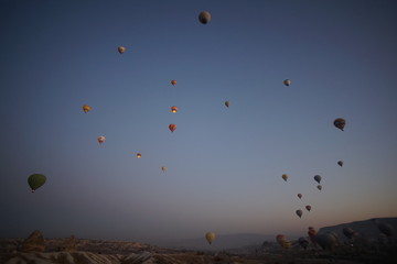 Hot air balloon flying over rock landscape at Cappadocia Turkey