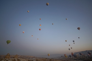 Hot air balloon flying over rock landscape at Cappadocia Turkey