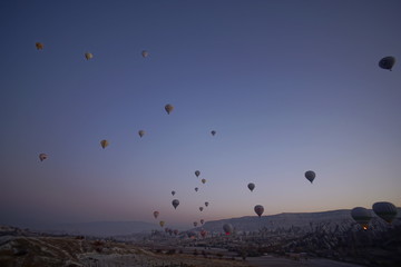 Hot air balloon flying over rock landscape at Cappadocia Turkey