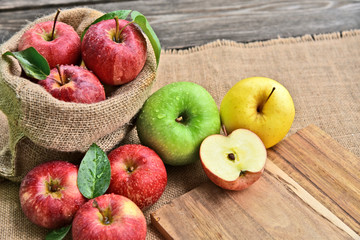 colorful of 3 Type of apple,Gala,Granny Smith,Golden Delicious with leaf in sack back and sack background.
