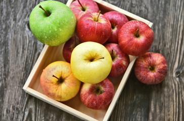 colorful of 3 Type of apple,Gala,Granny Smith,Golden Delicious in wooden box and wooden background.
